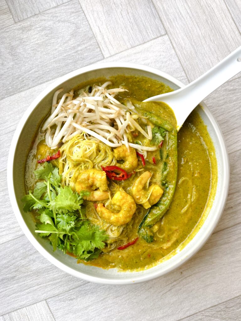 Bowl of prawn laska made using Smarter Naturally broccoli soup