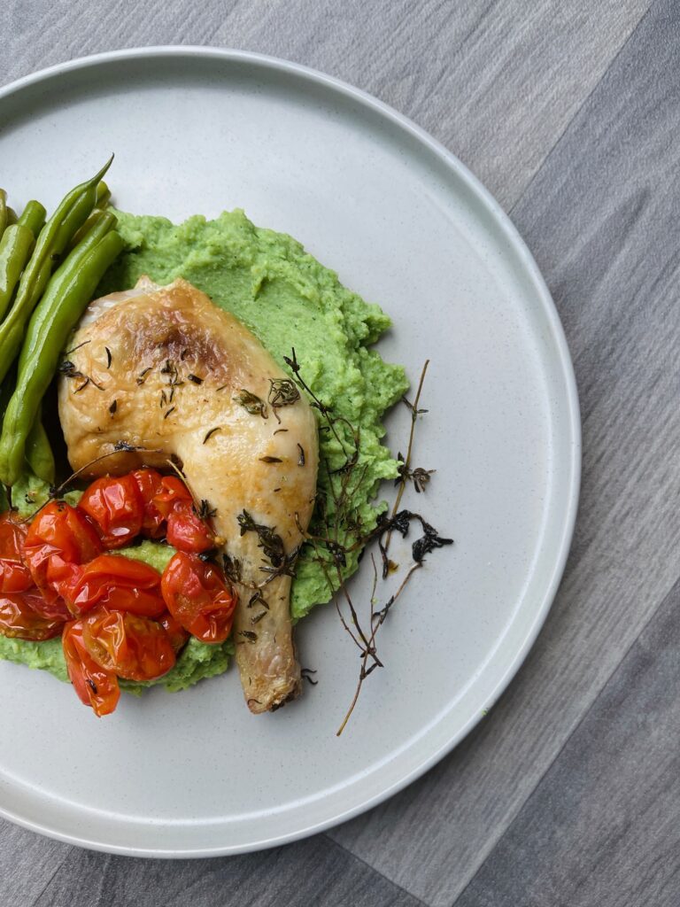 Smarter Naturally broccoli soup and mustard mash with chicken, tomatoes and green beans, served on a white plate