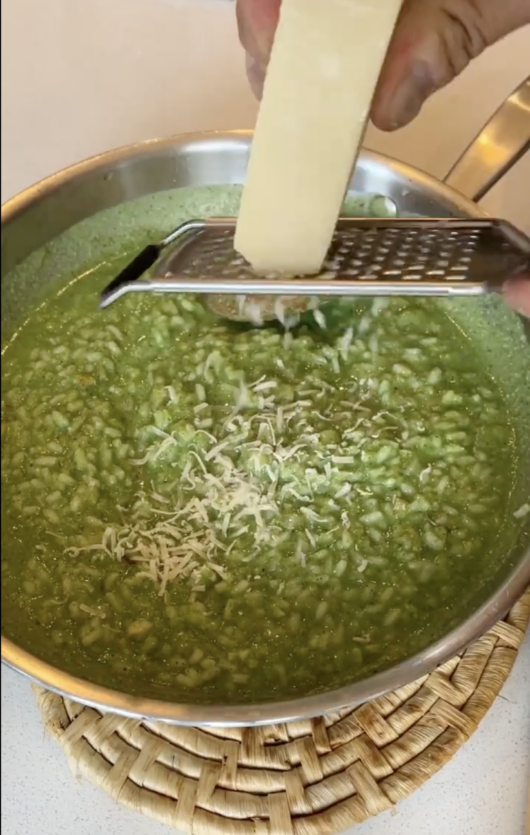 Grating parmesan into SmarterNaturally SuperSoup broccoli risotto