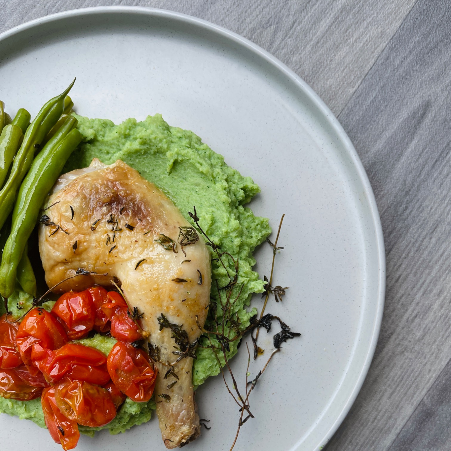 Delicious plate of roast chicken and broccoli and mustard mash with beans and tomatoes